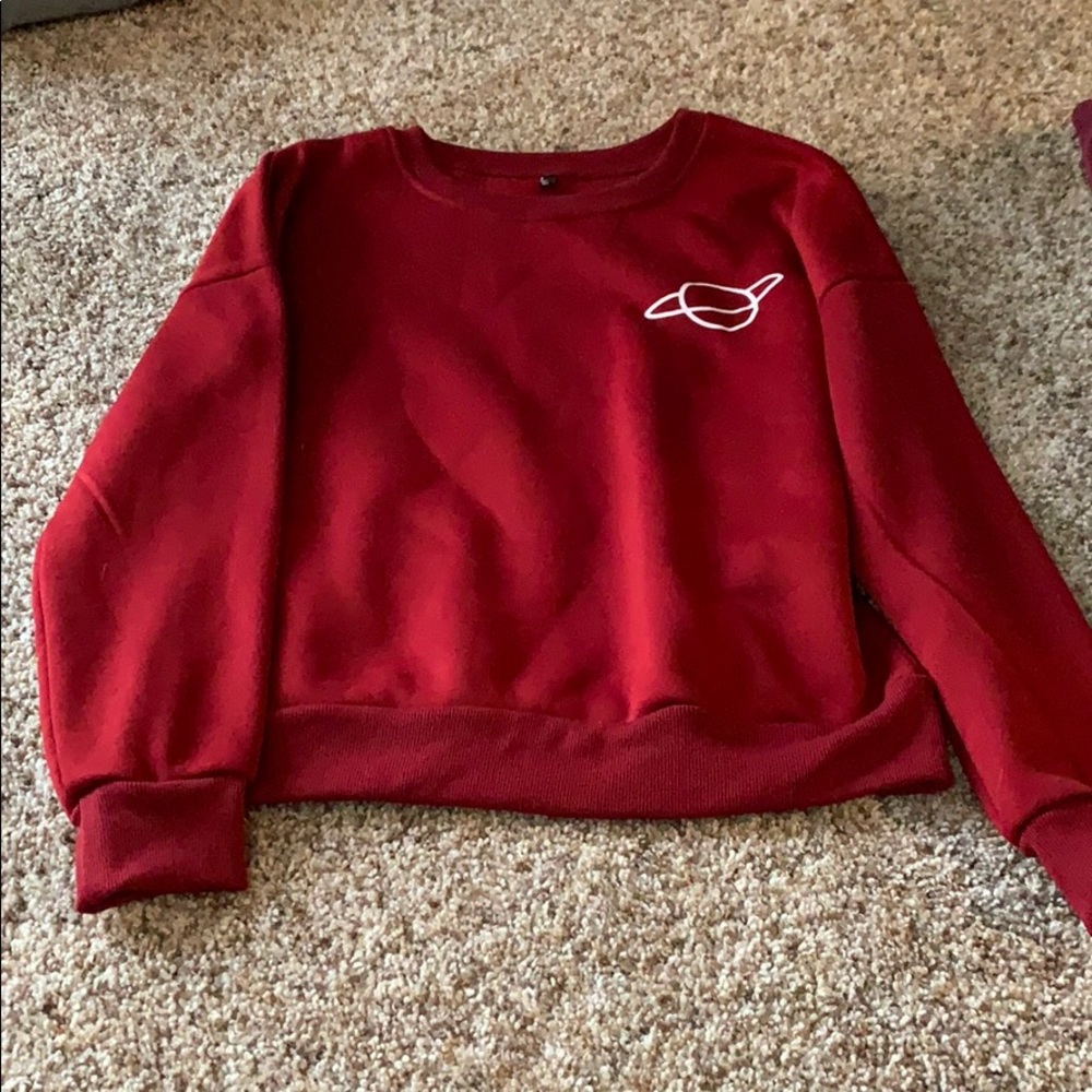 Red sweatshirt with planet on left chest